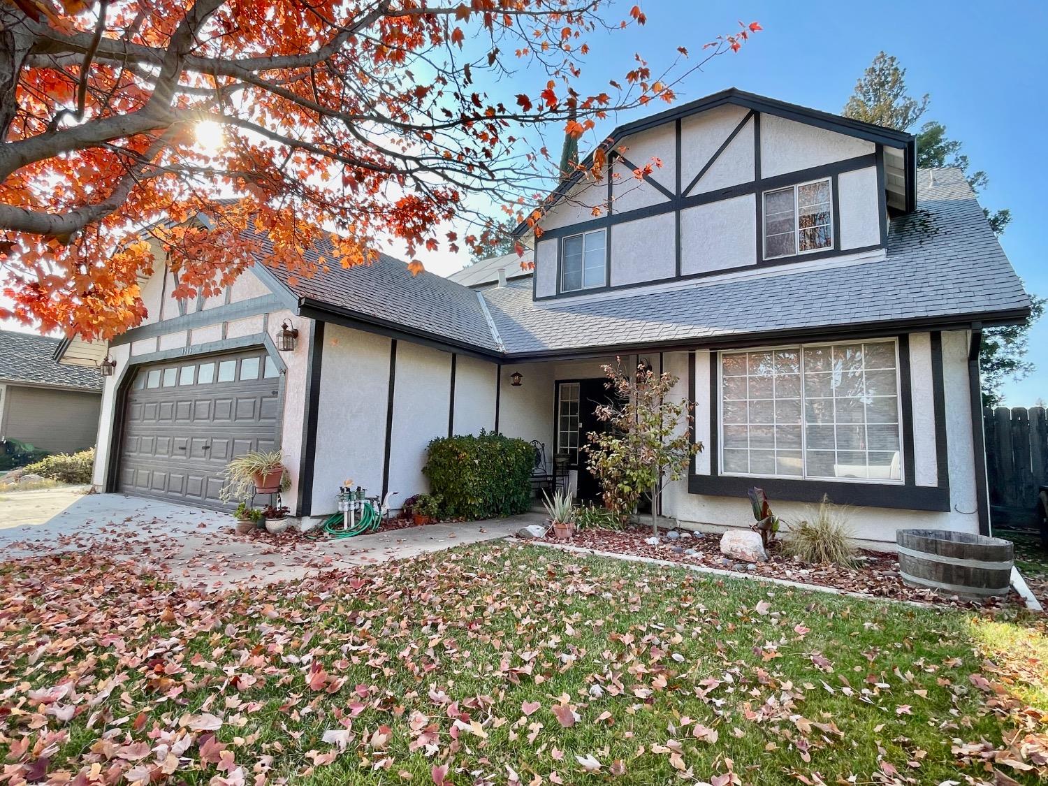 a front view of house with a garden