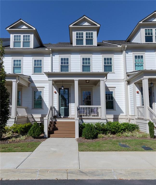 a front view of a residential apartment building with a yard