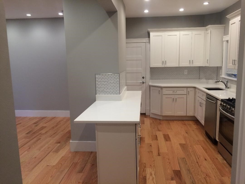 a kitchen with a sink appliances and cabinets