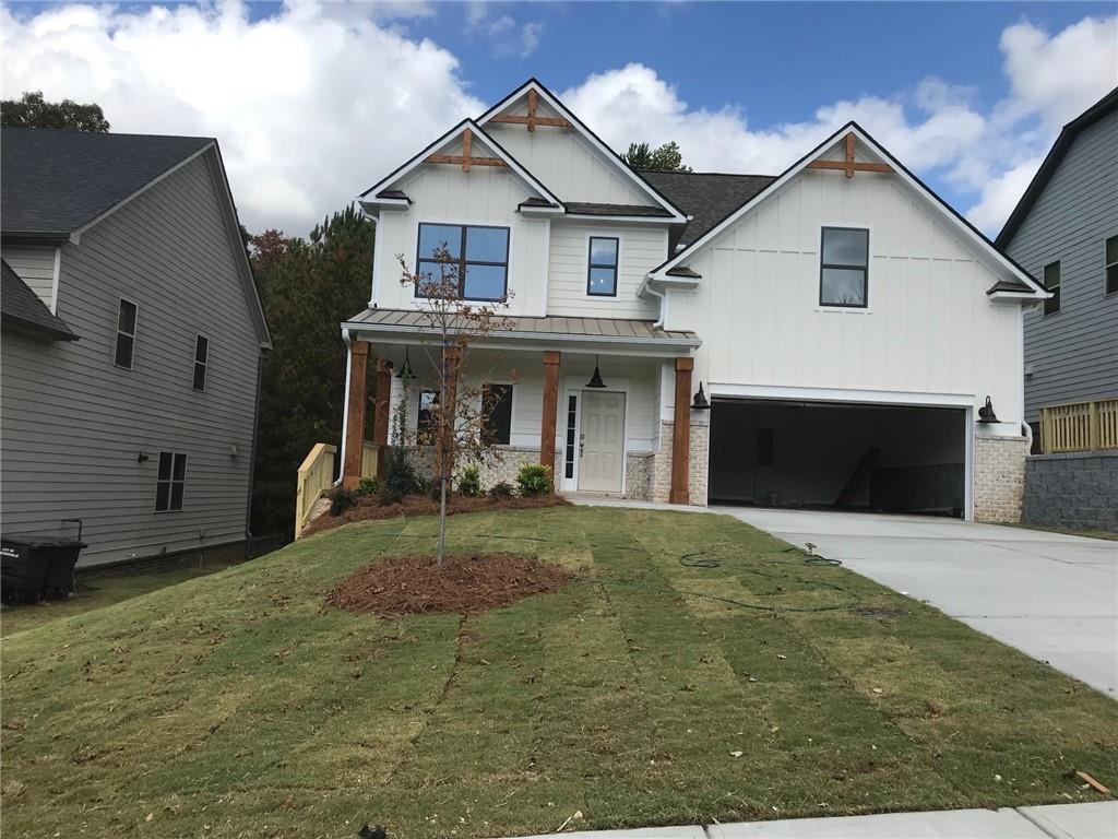 a front view of a house with yard and parking