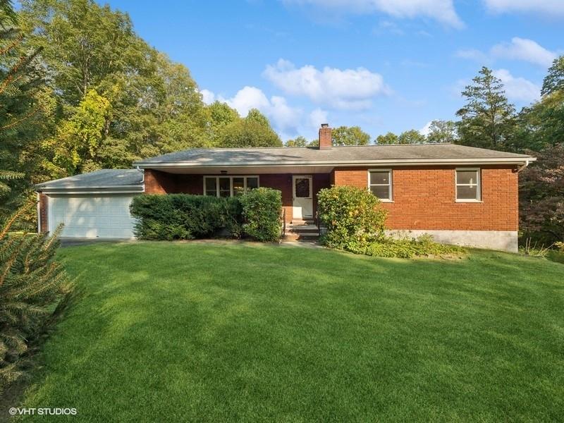 a front view of house with yard and green space