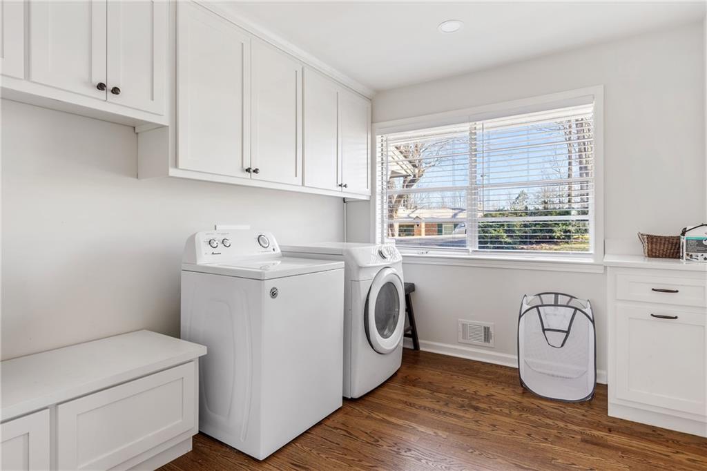 a utility room with sink dryer and washer