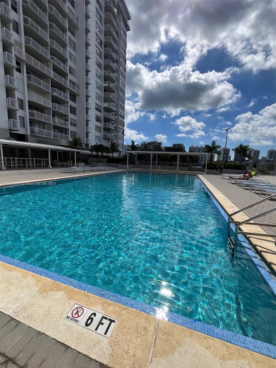 a view of a swimming pool with a yard