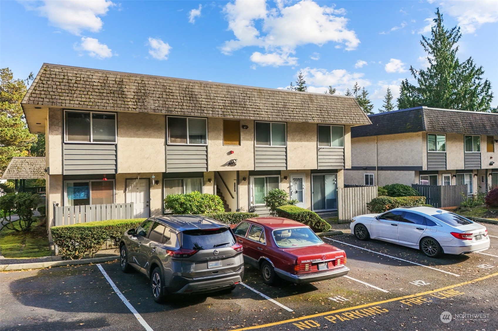 a front view of a house with parking space