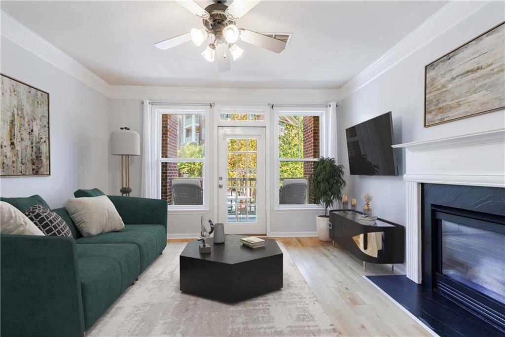 a living room with furniture a flat screen tv and a fireplace