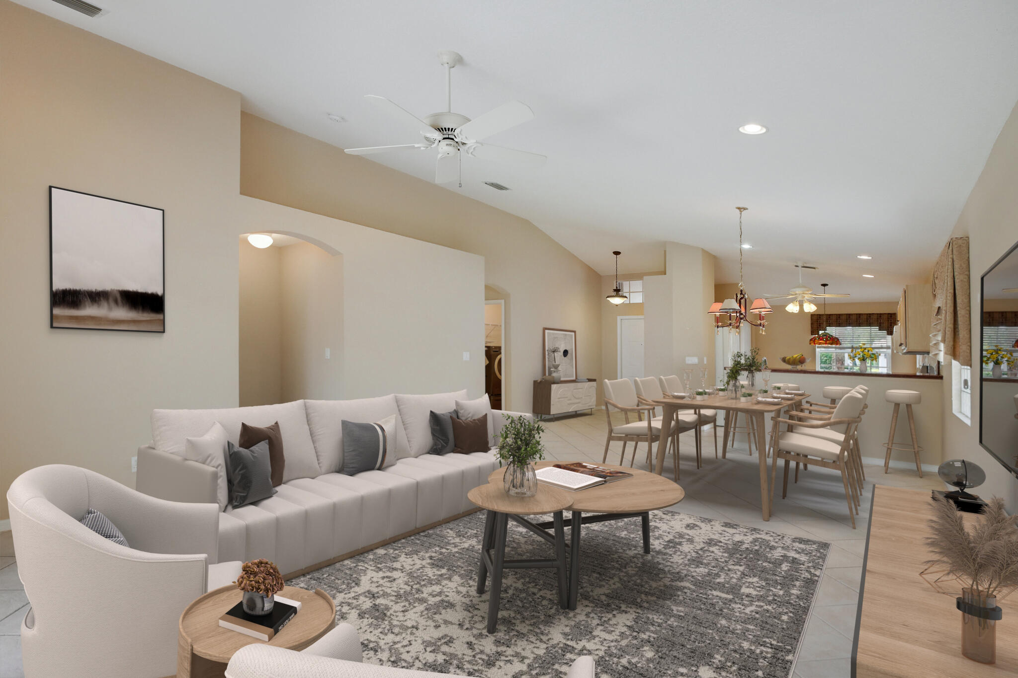 a living room with furniture and view of kitchen