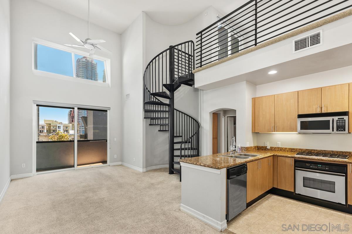 a large kitchen with cabinets and stainless steel appliances