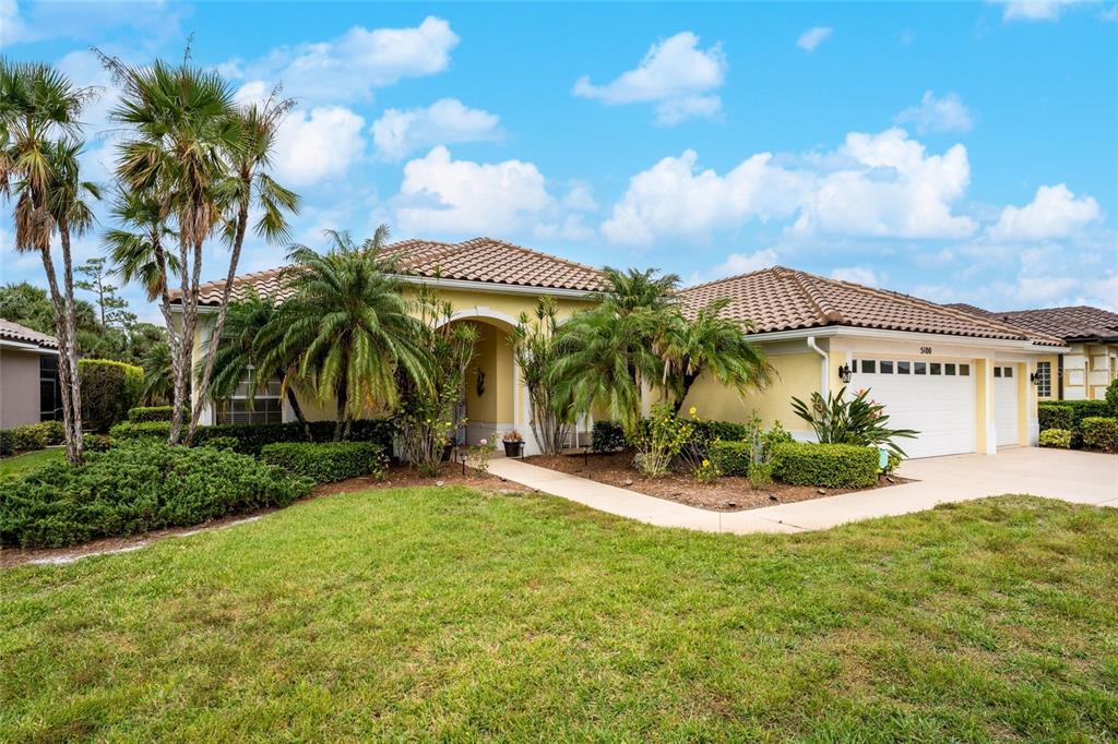 a view of a house with palm trees