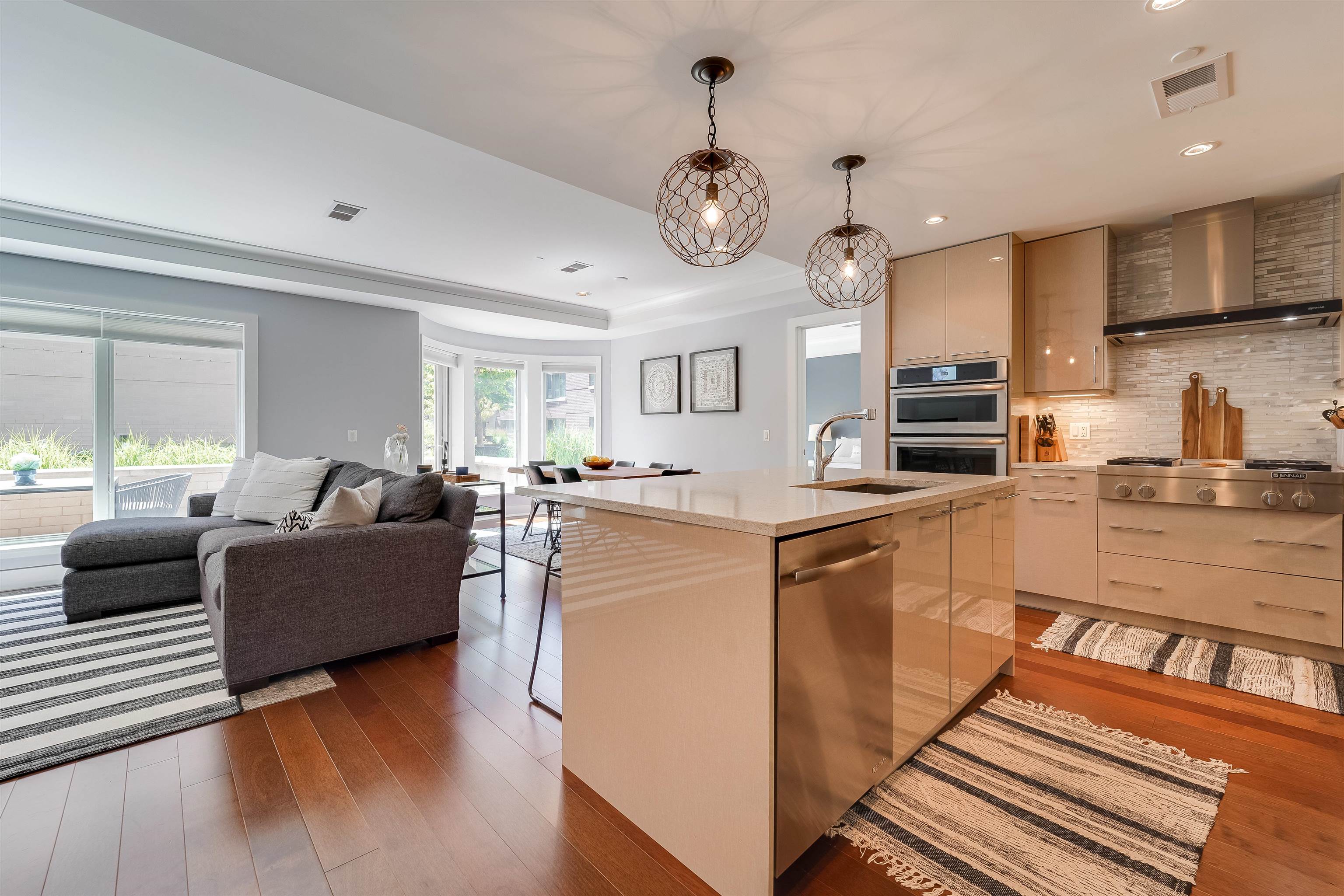 a living room with stainless steel appliances kitchen island granite countertop furniture and a kitchen view