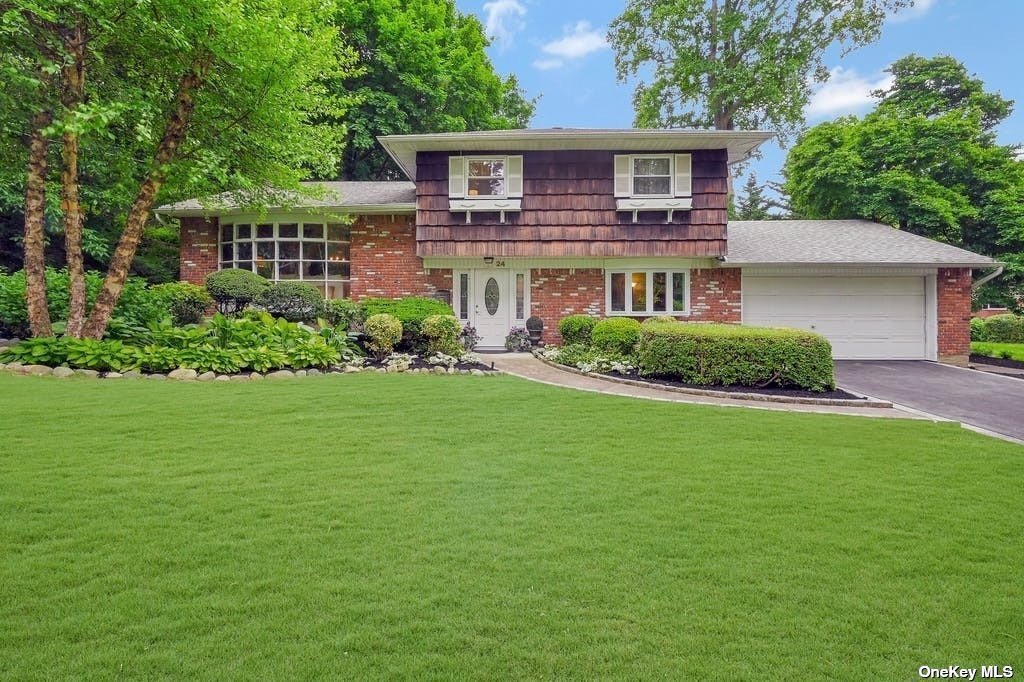 a front view of a house with a garden