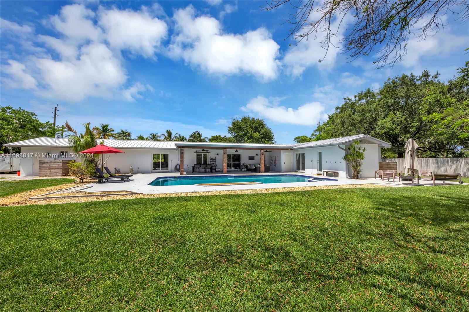 a front view of house with yard and outdoor seating