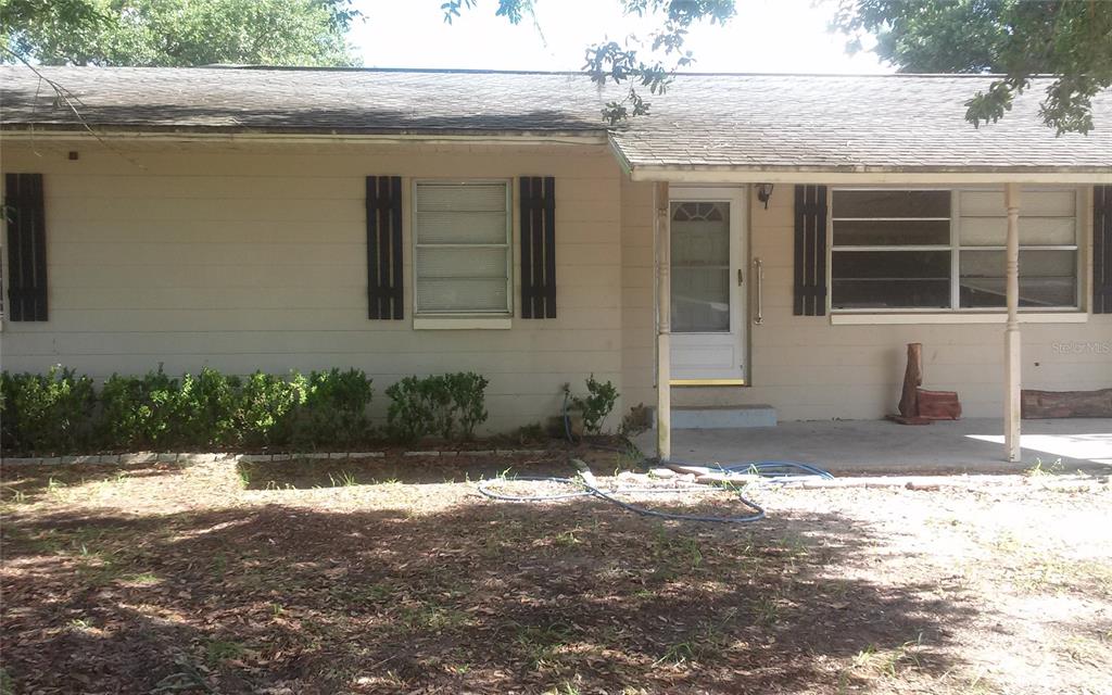 a view of house with yard