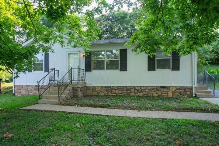 a view of house with a backyard