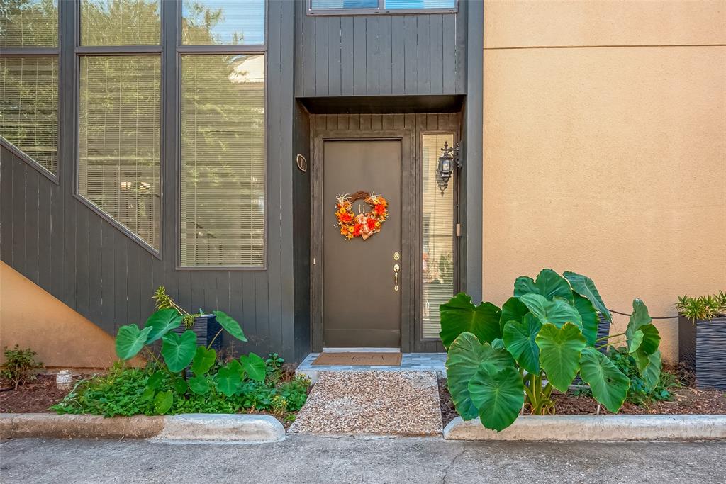 a front view of a house with potted plants