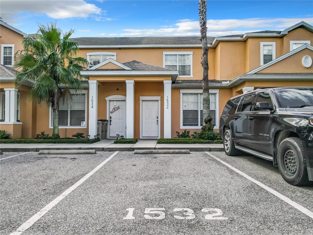 front view of a house with a cars parked in front of it