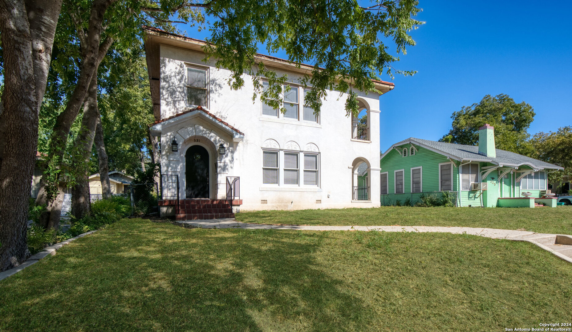 a front view of a house with a garden