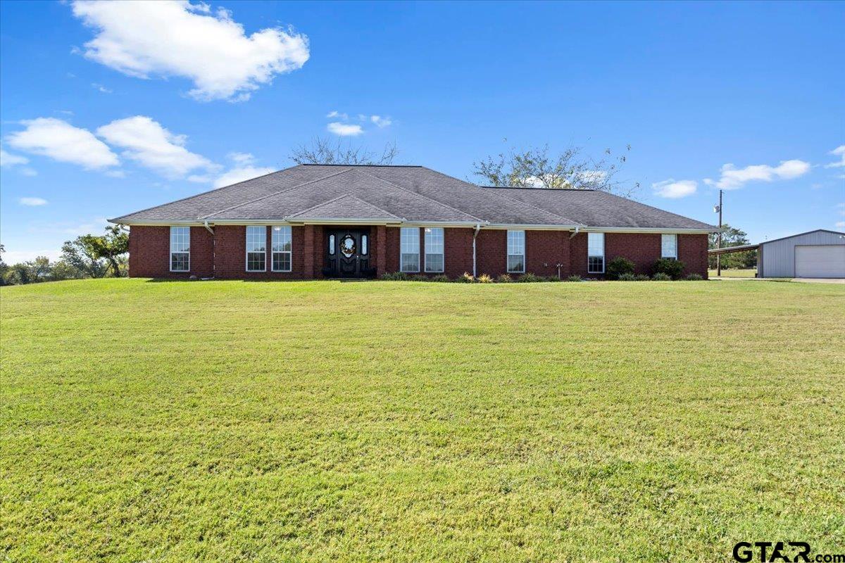 a large house with a big yard and large trees