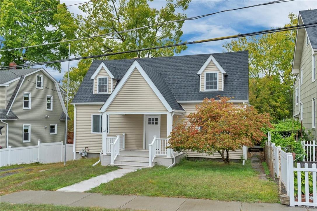 a front view of a house with a garden