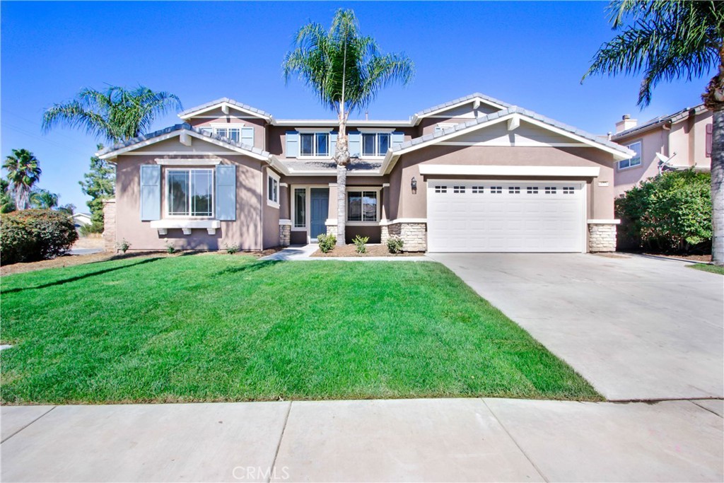 a view of a house with a big yard and potted plants