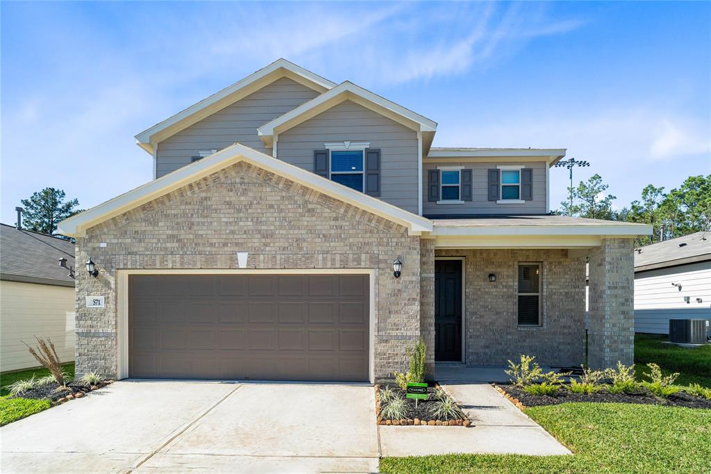 Welcome home to 571 Broken Boulder Street located in Mustang Ridge and zoned to Magnolia ISD.