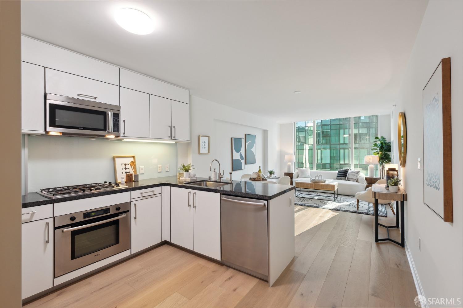 a kitchen with stainless steel appliances a stove sink microwave and cabinets