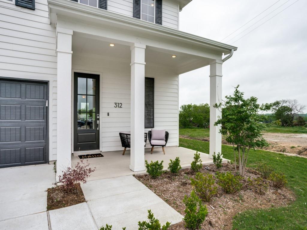 a view of a porch with potted plants