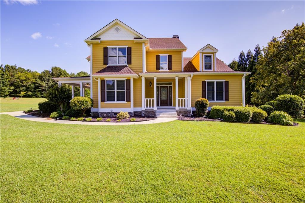 a front view of house with yard and green space