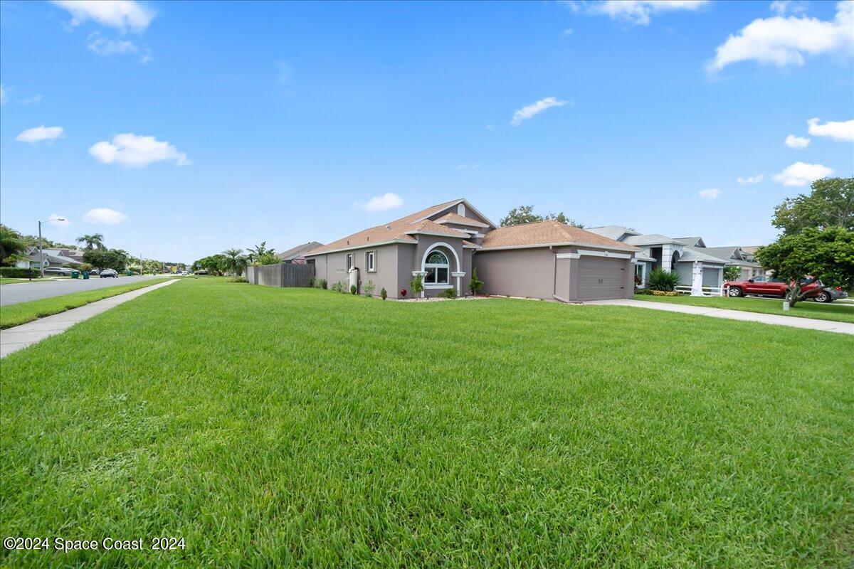 a view of a house with a yard and sitting area