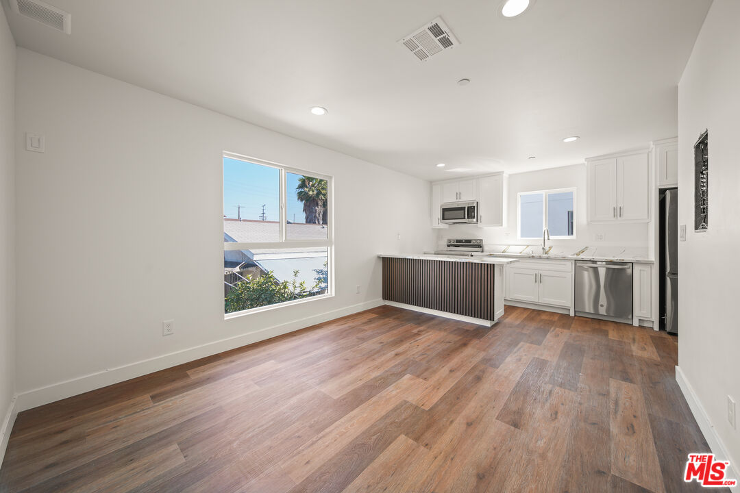 a view of kitchen with wooden floor and window