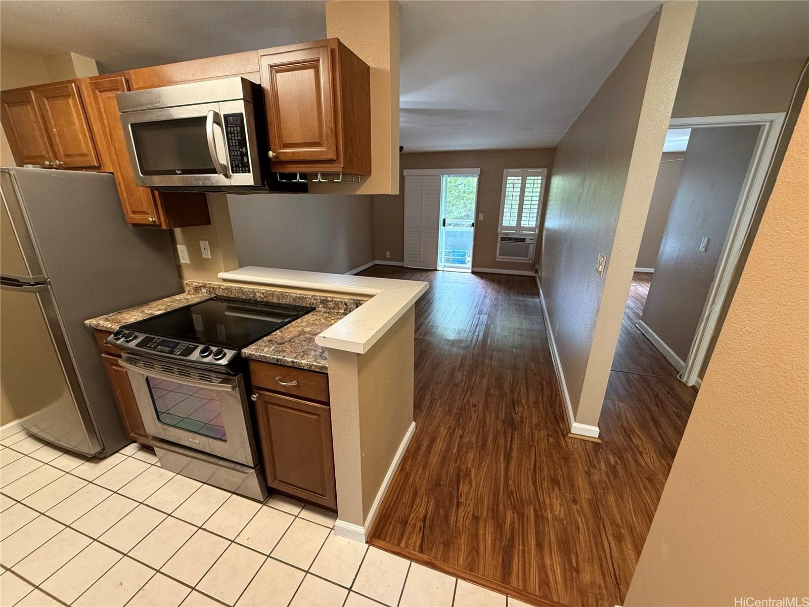 a kitchen with granite countertop a stove top oven and sink