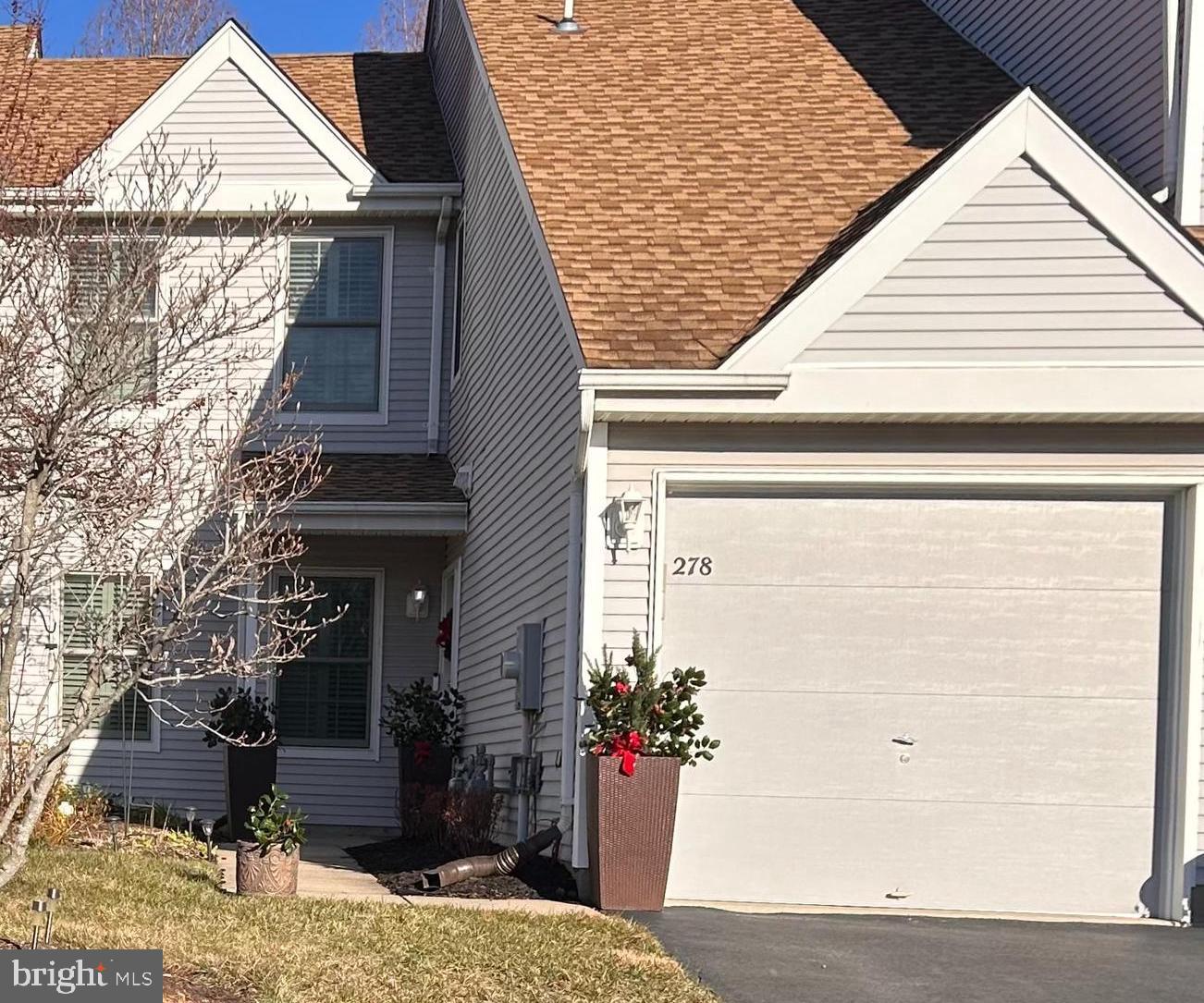 a view of a house with a potted plant