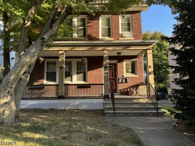 a view of a house with a small yard