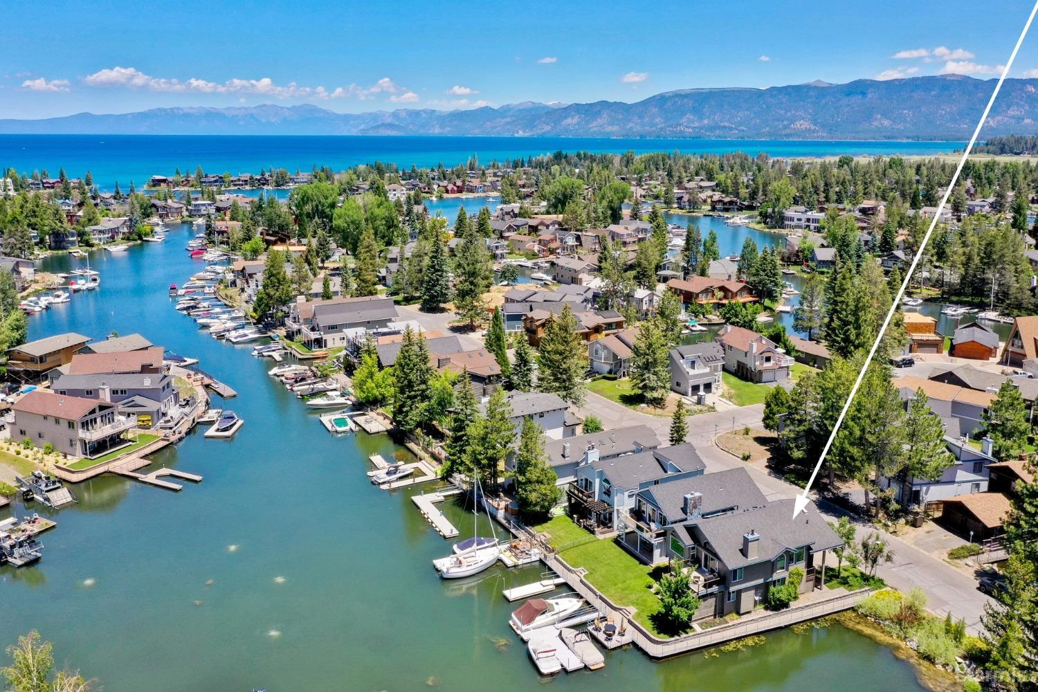 an aerial view of residential houses with outdoor space and river view