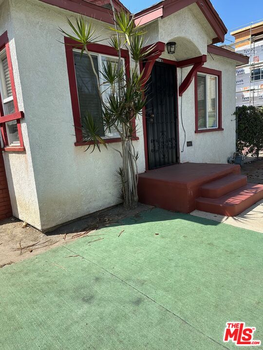 a backyard of a house with table and chairs