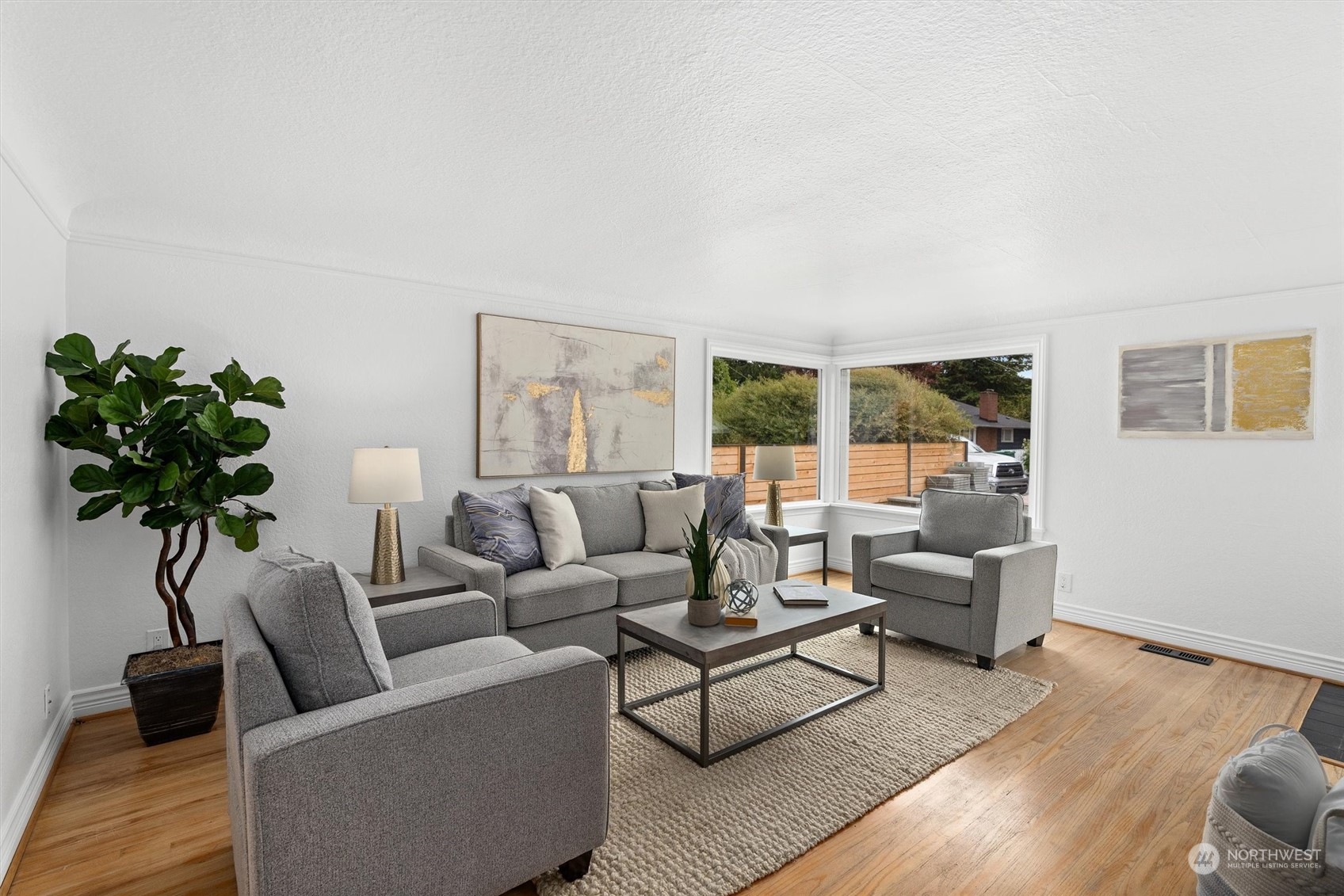 a living room with furniture and a potted plant