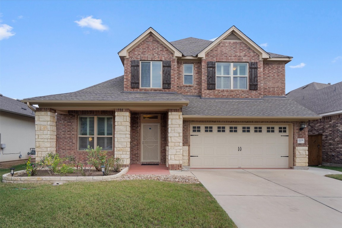 This beautiful house has a welcoming front porch and clean curb appeal.