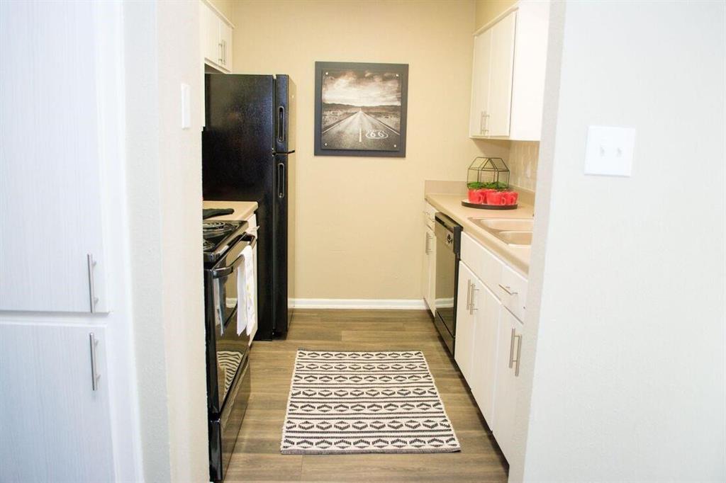 a bathroom with a refrigerator and a window