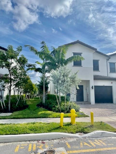 a front view of a house with a yard