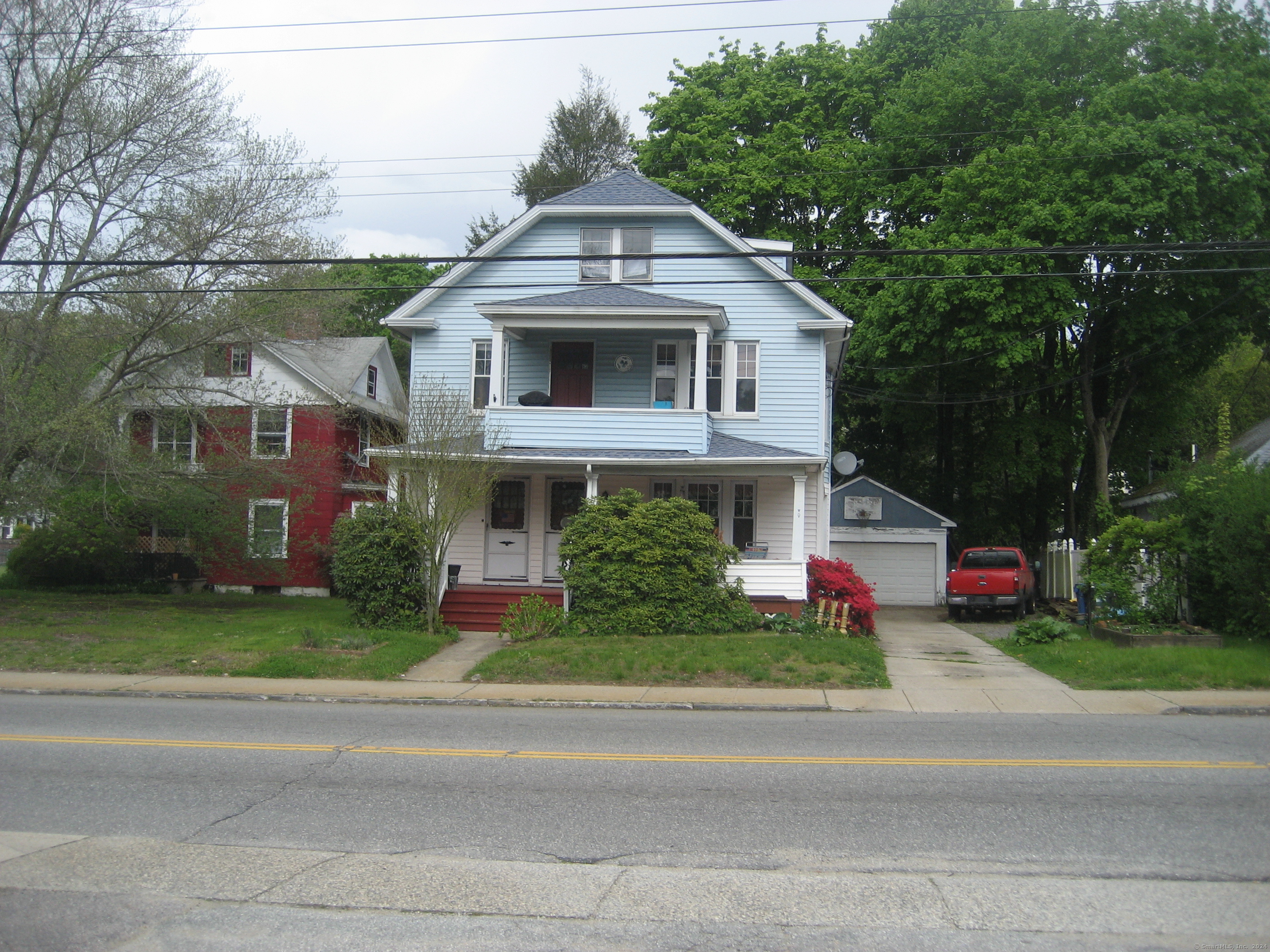 a front view of house with yard and green space