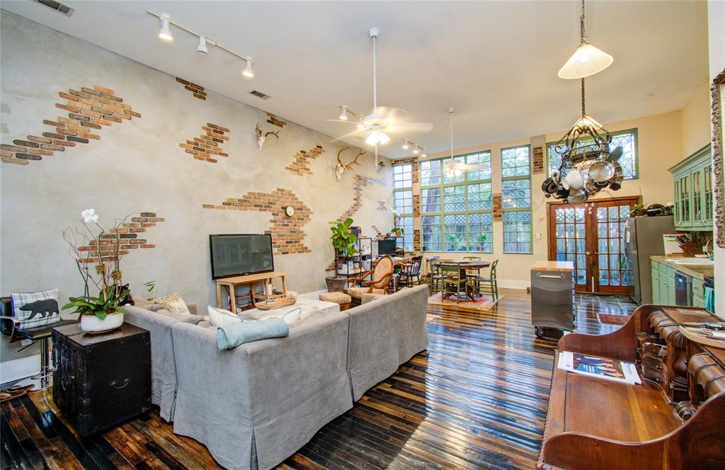 a living room with furniture a chandelier and a flat screen tv