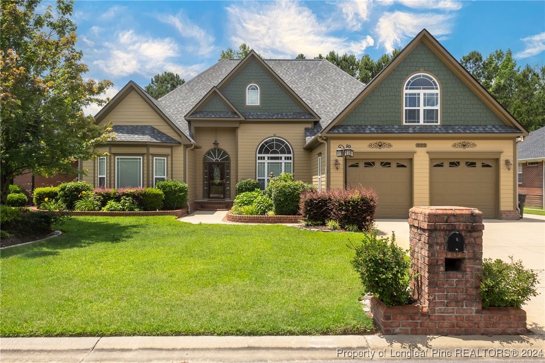 a front view of a house with garden