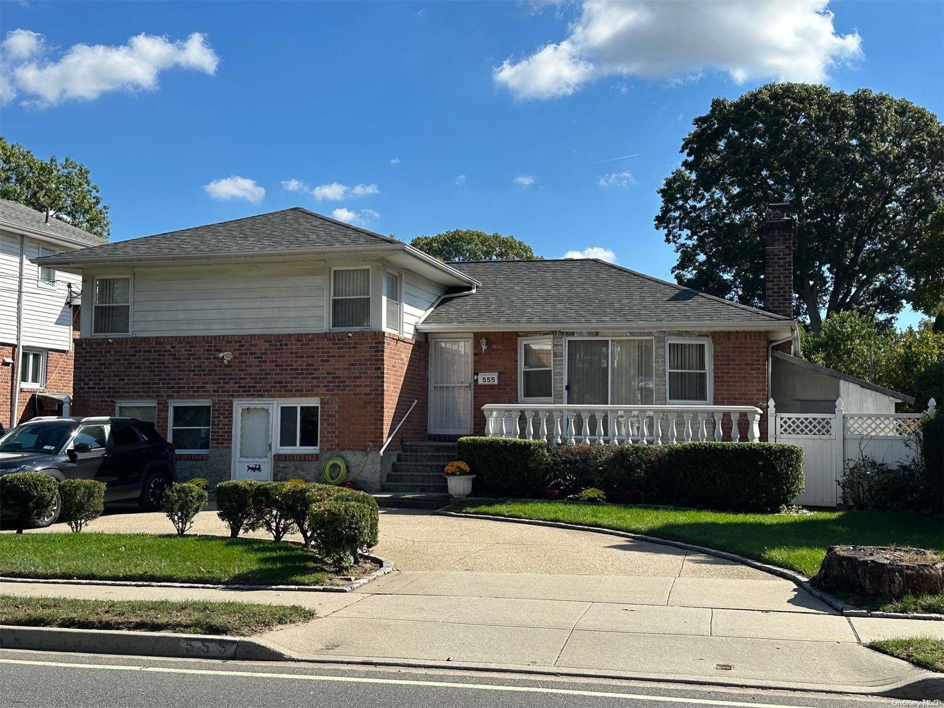 a front view of a house with a garden