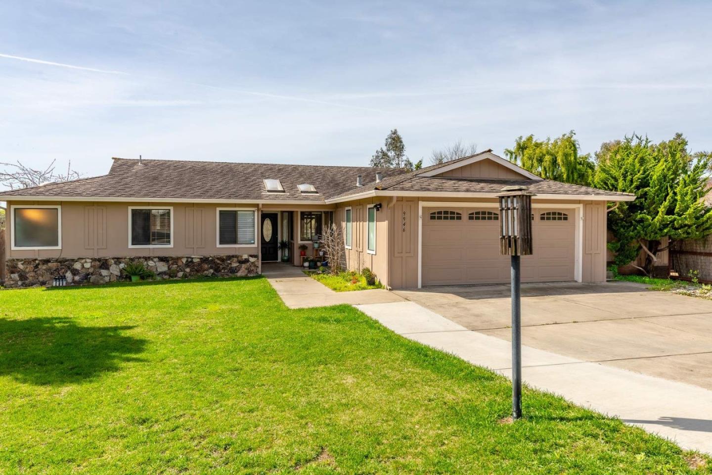 a front view of a house with a garden and yard