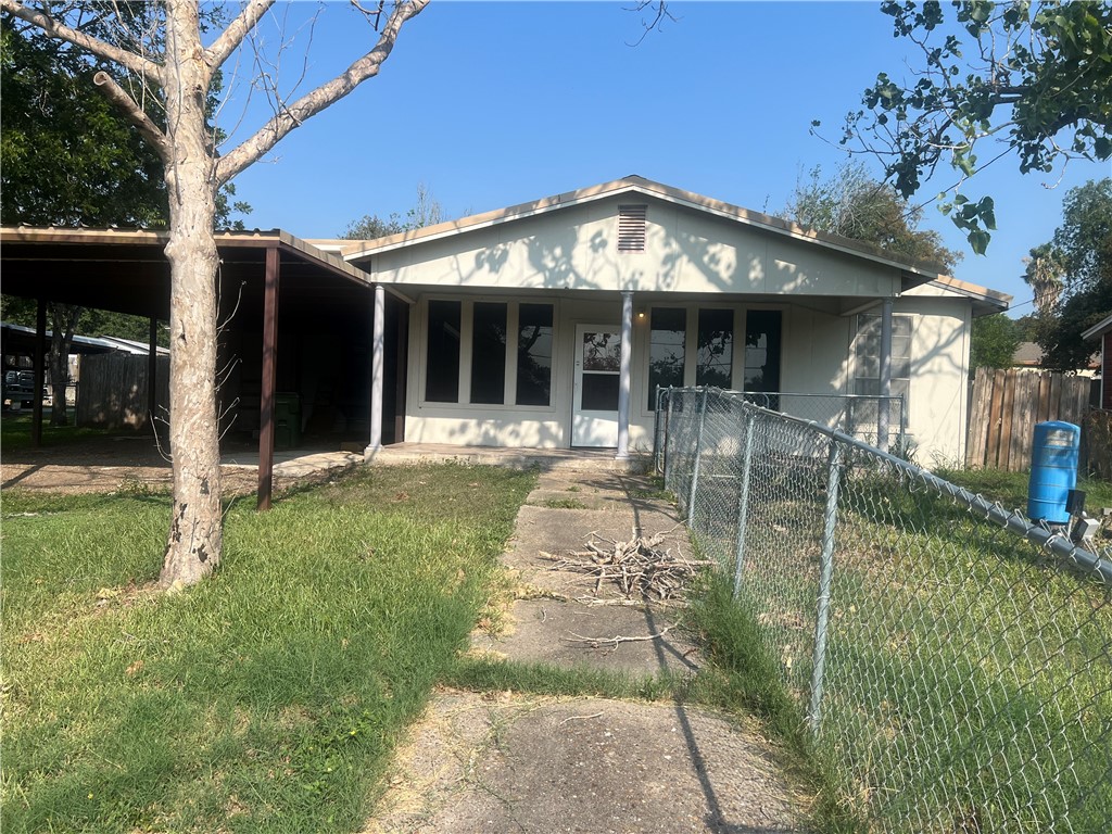 a front view of a house with a garden and patio