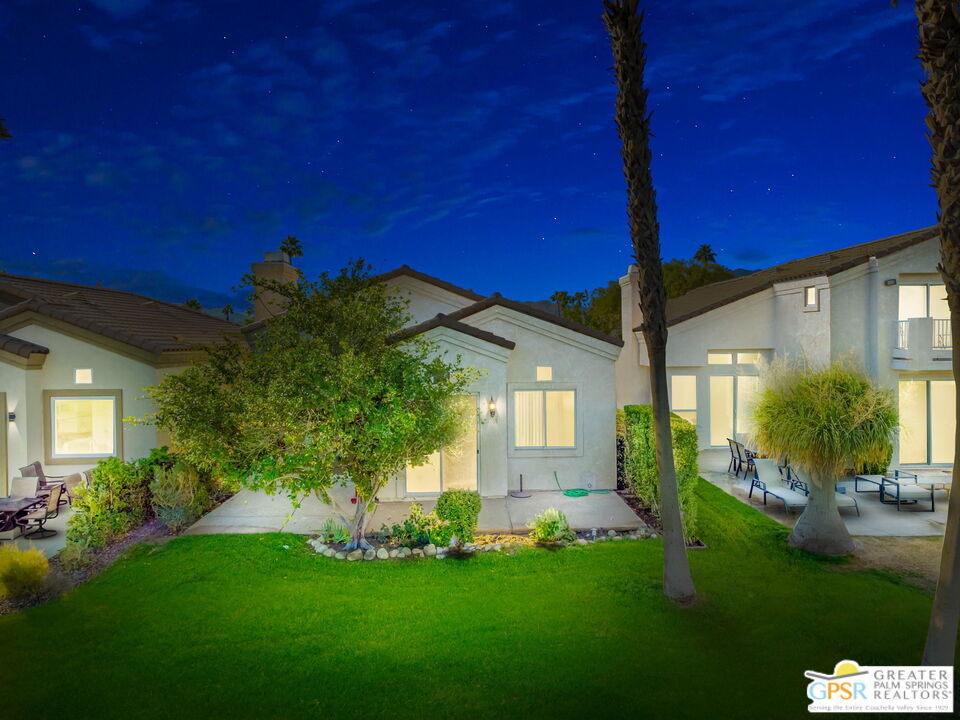 a view of a house with a backyard