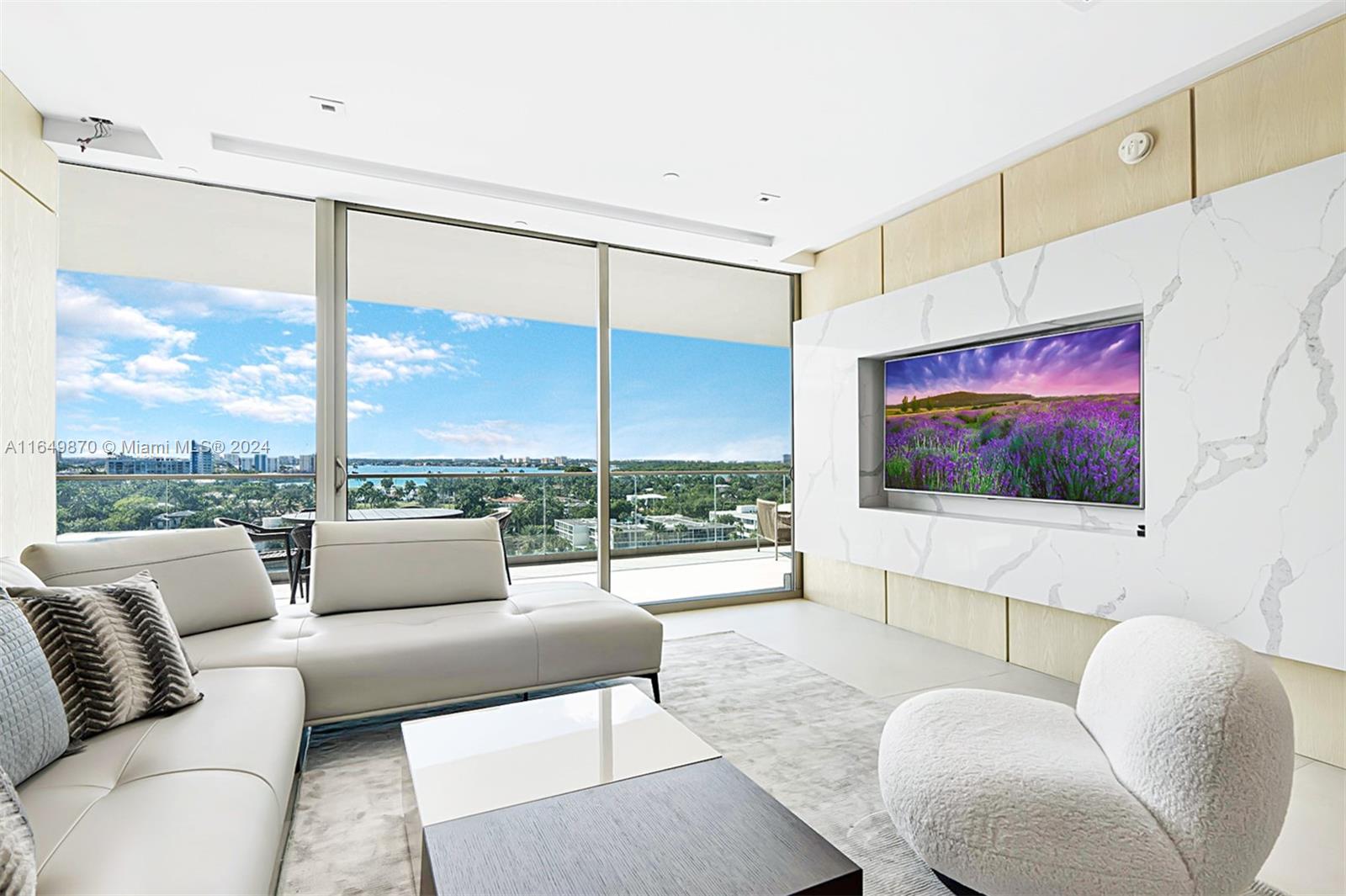 a living room with furniture tv and a floor to ceiling window