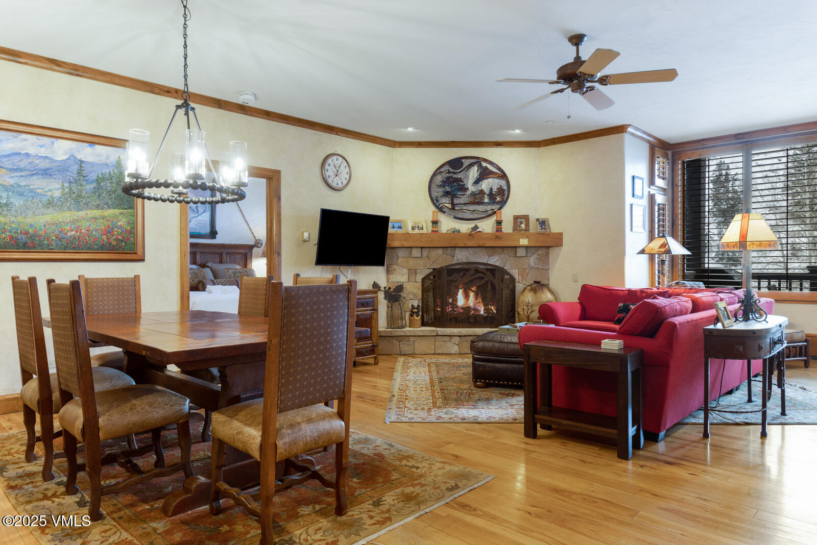 a living room with furniture a fireplace and a floor to ceiling window