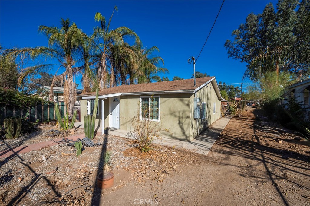 a view of a house with a tree in front of it