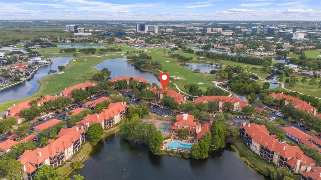 an aerial view of lake and residential houses with outdoor space