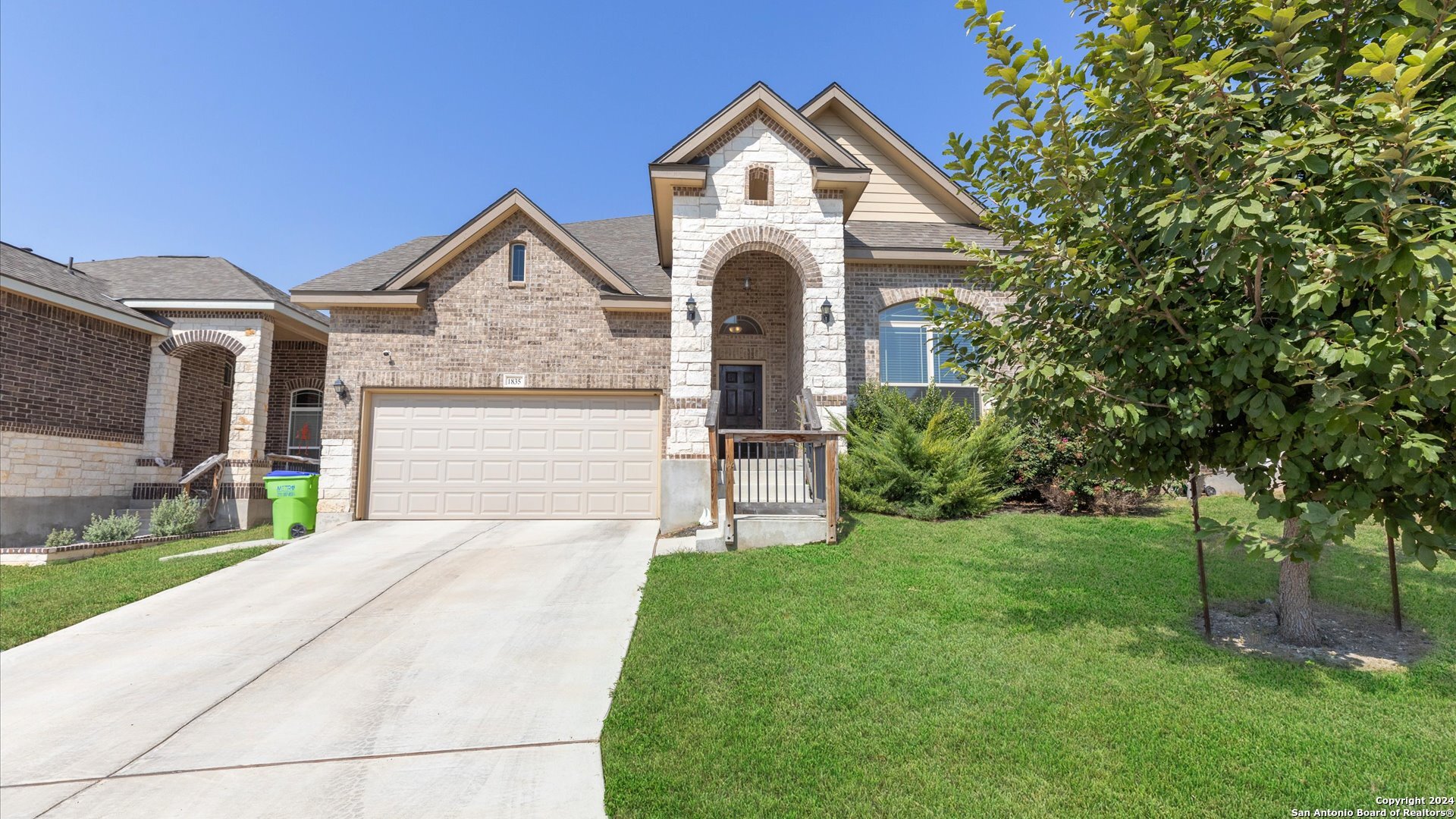 a front view of a house with a yard and garage